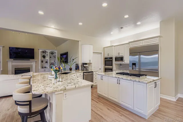 a bedroom with a bed a flat screen tv and a couch