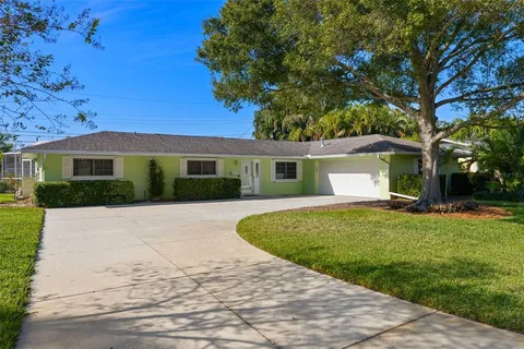 a view of a white house with a yard