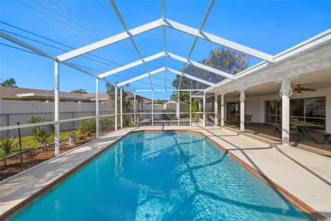 a view of a backyard with swimming pool