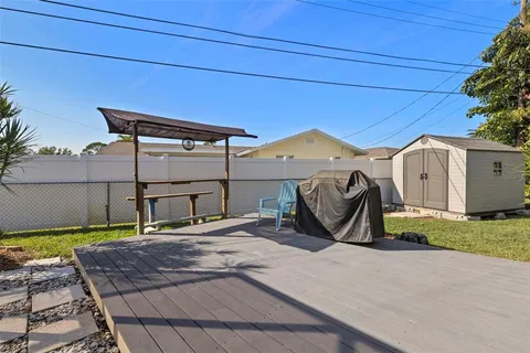 a view of a house with a patio and a yard