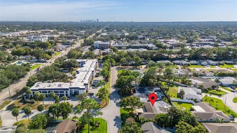 an aerial view of residential building with green space