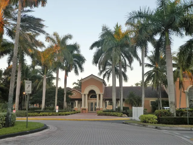 a front view of a house with a garden and trees