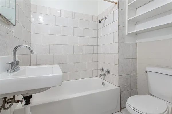a white bath tub sitting next to a white sink