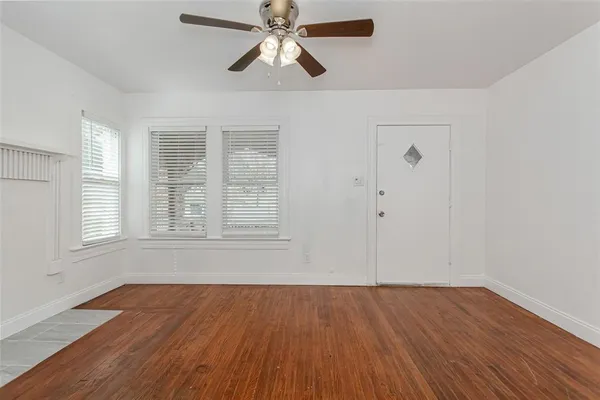 wooden floor in an empty room with a window