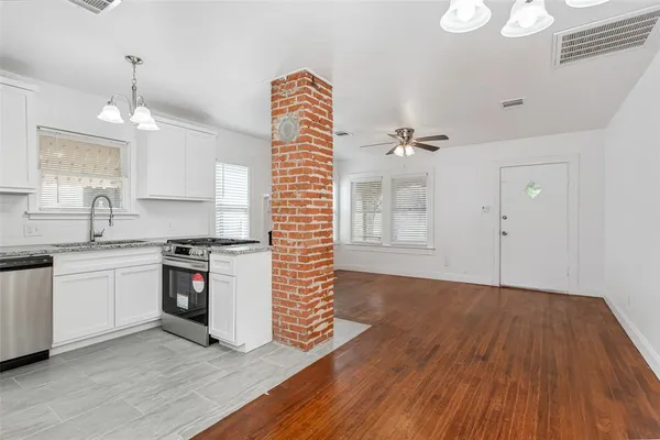 a kitchen with granite countertop a stove and a sink