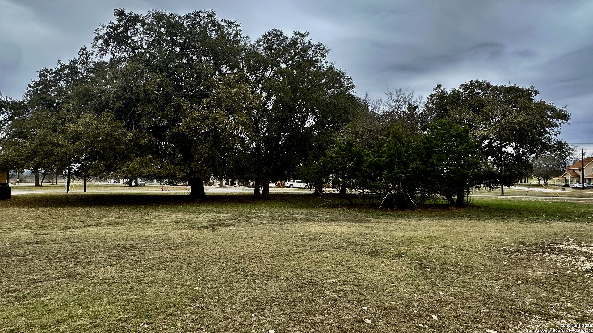 0 Tawny Oak Bandera, TX 78003 - Photo 2 of 13 a view of a patio with chairs and a yard