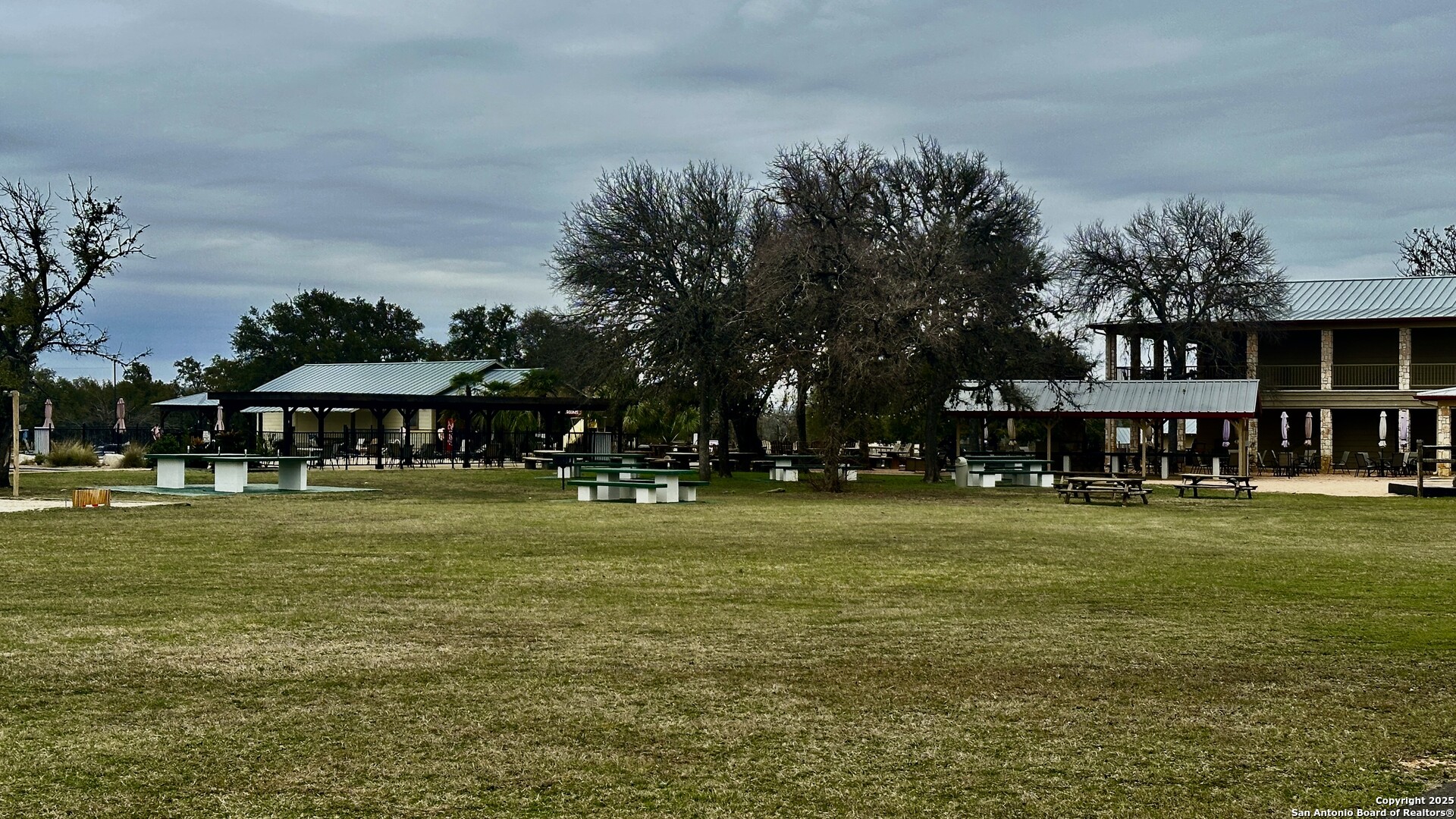 0 Tawny Oak Bandera, TX 78003 - Photo 10 of 13 a view of a big house with a big yard and potted plants and large trees