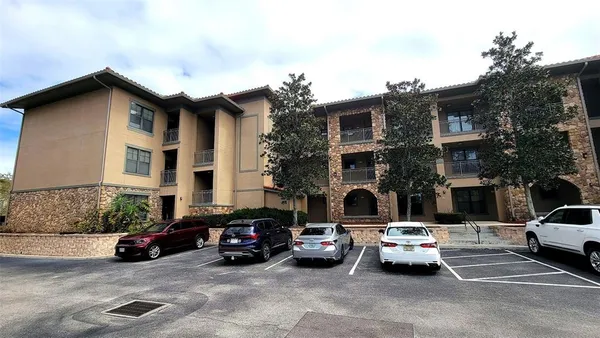 a view of a cars park in front of a building