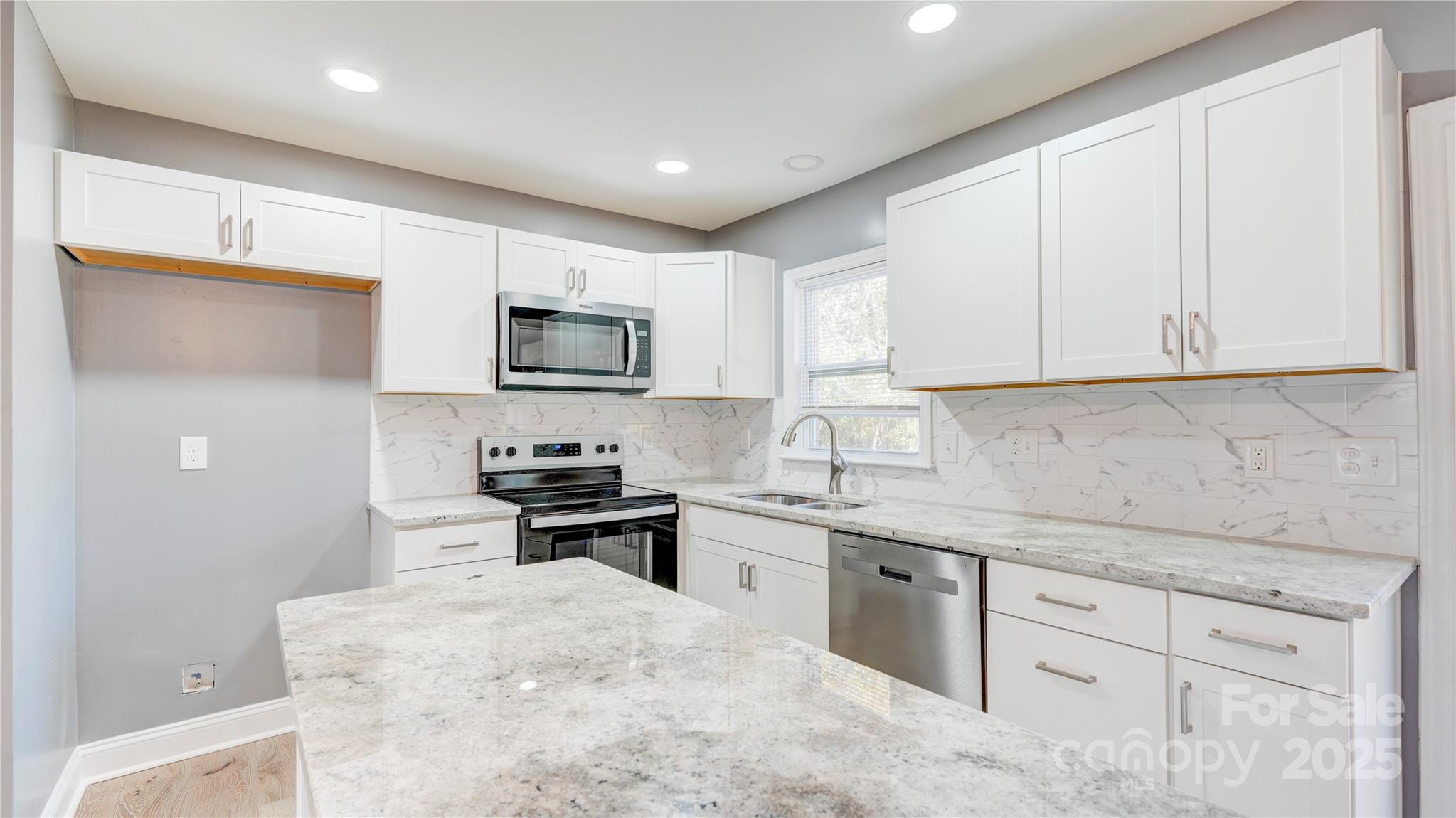 460 Chalk Maple Road China Grove, NC 28023 - Photo 11 of 33 a kitchen with granite countertop white cabinets sink and stainless steel appliances