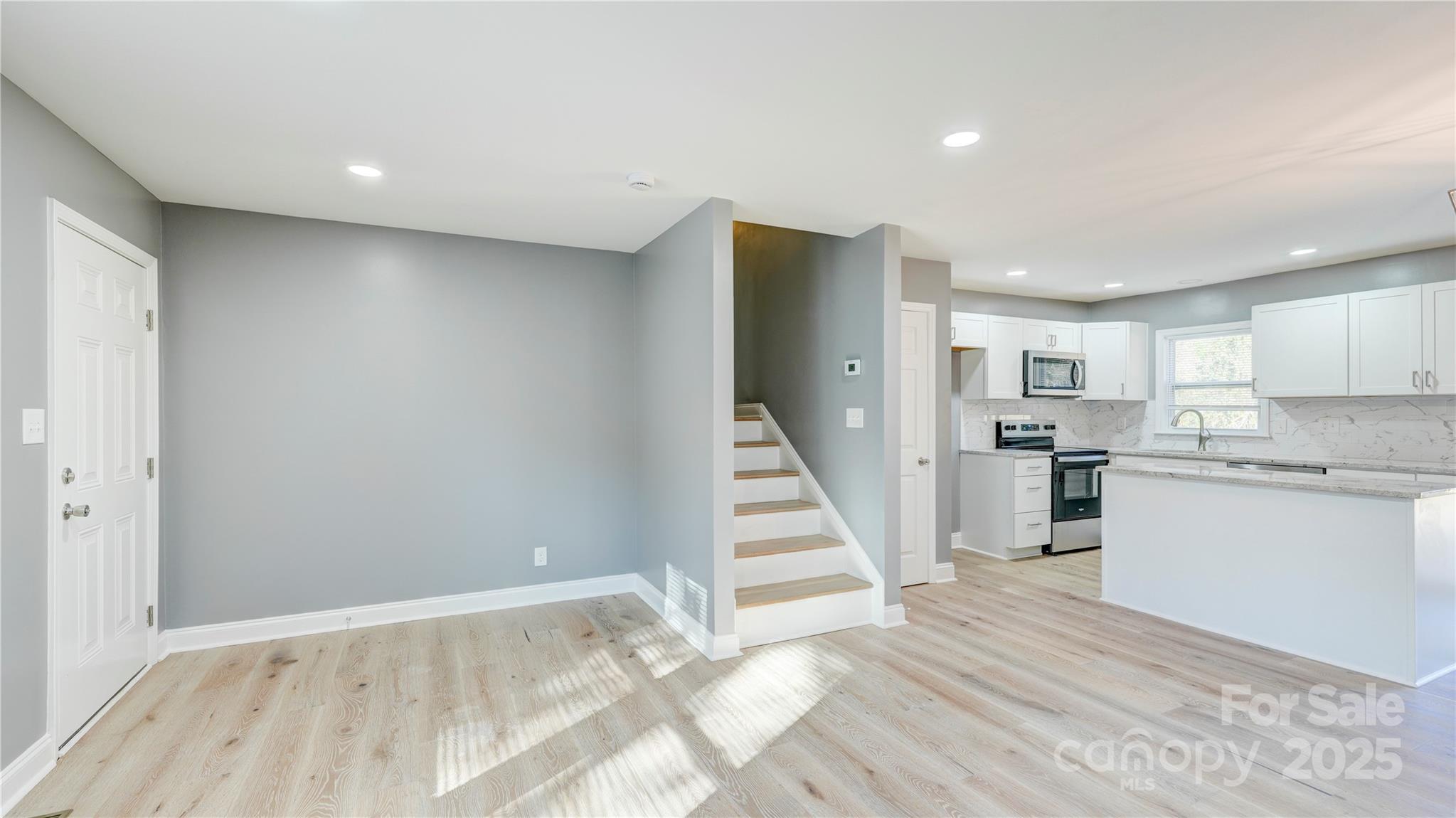460 Chalk Maple Road China Grove, NC 28023 - Photo 13 of 33 a view of a kitchen with wooden floor and staircase