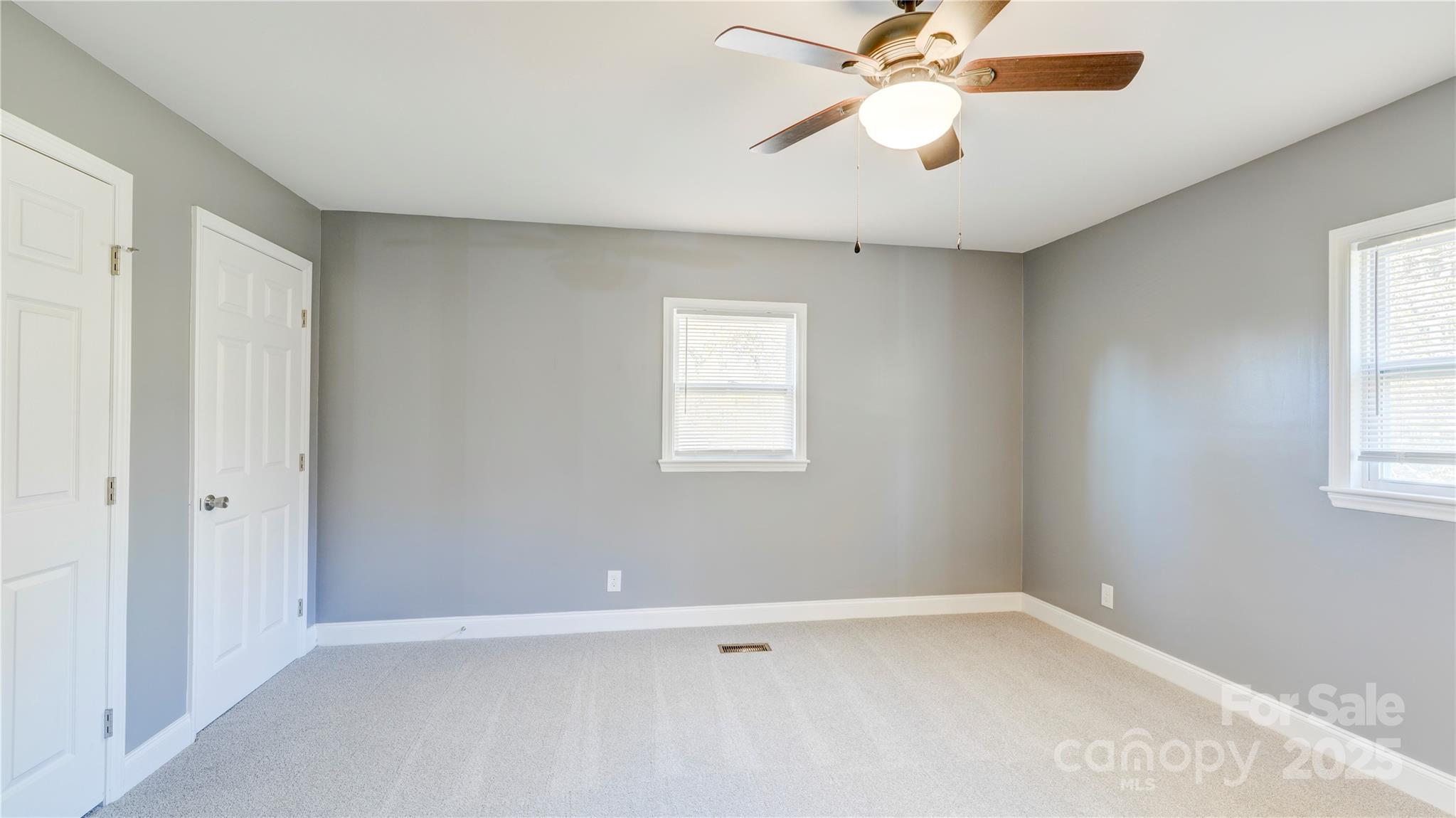 460 Chalk Maple Road China Grove, NC 28023 - Photo 21 of 33 an empty room with chandelier fan and windows