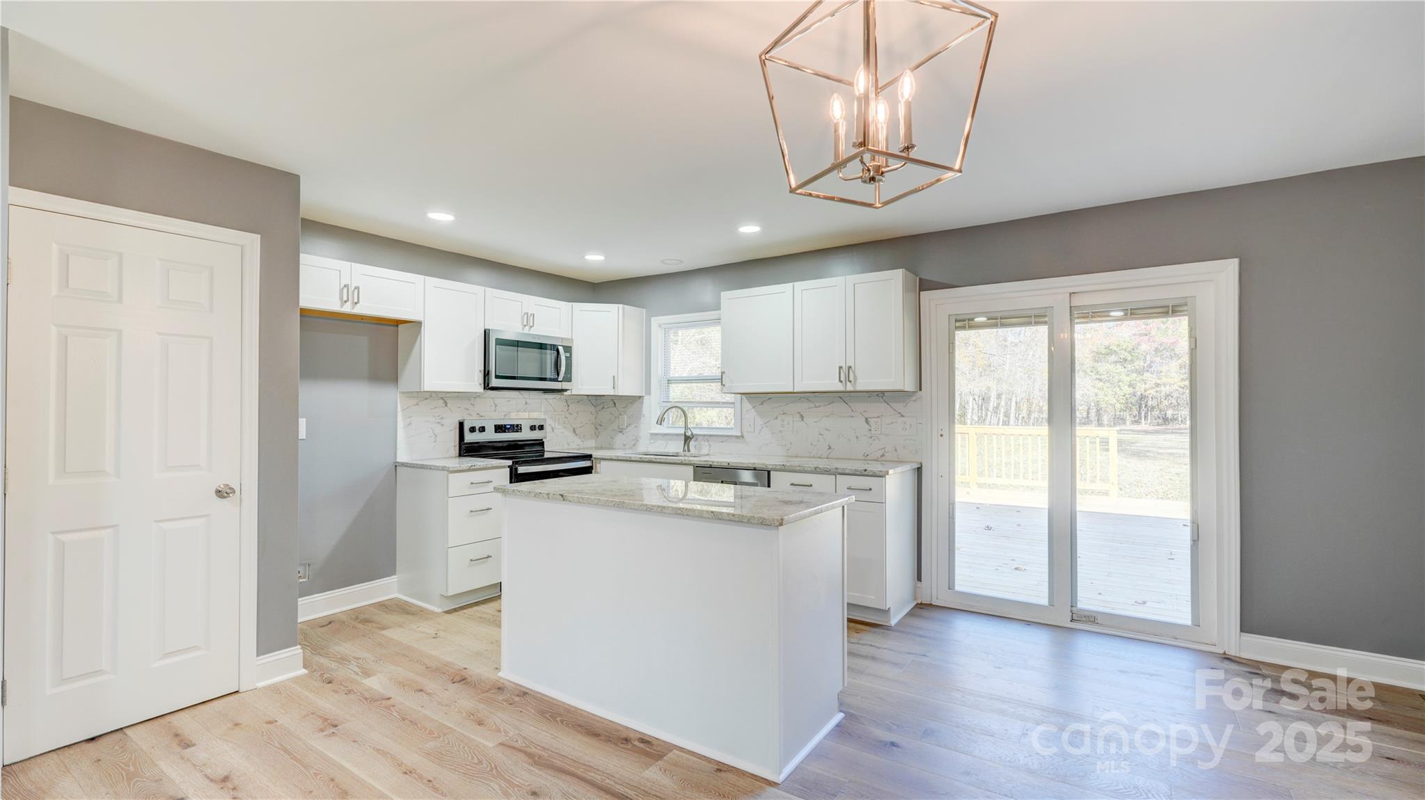 460 Chalk Maple Road China Grove, NC 28023 - Photo 7 of 33 a kitchen with stainless steel appliances granite countertop a sink a stove a refrigerator cabinets and a window