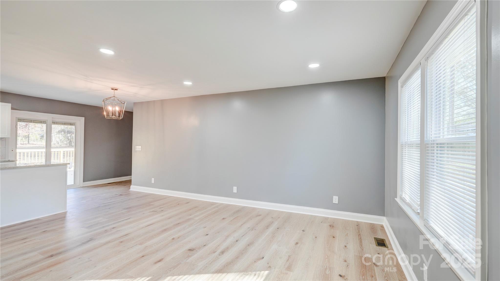 460 Chalk Maple Road China Grove, NC 28023 - Photo 8 of 33 an empty room with wooden floor and windows