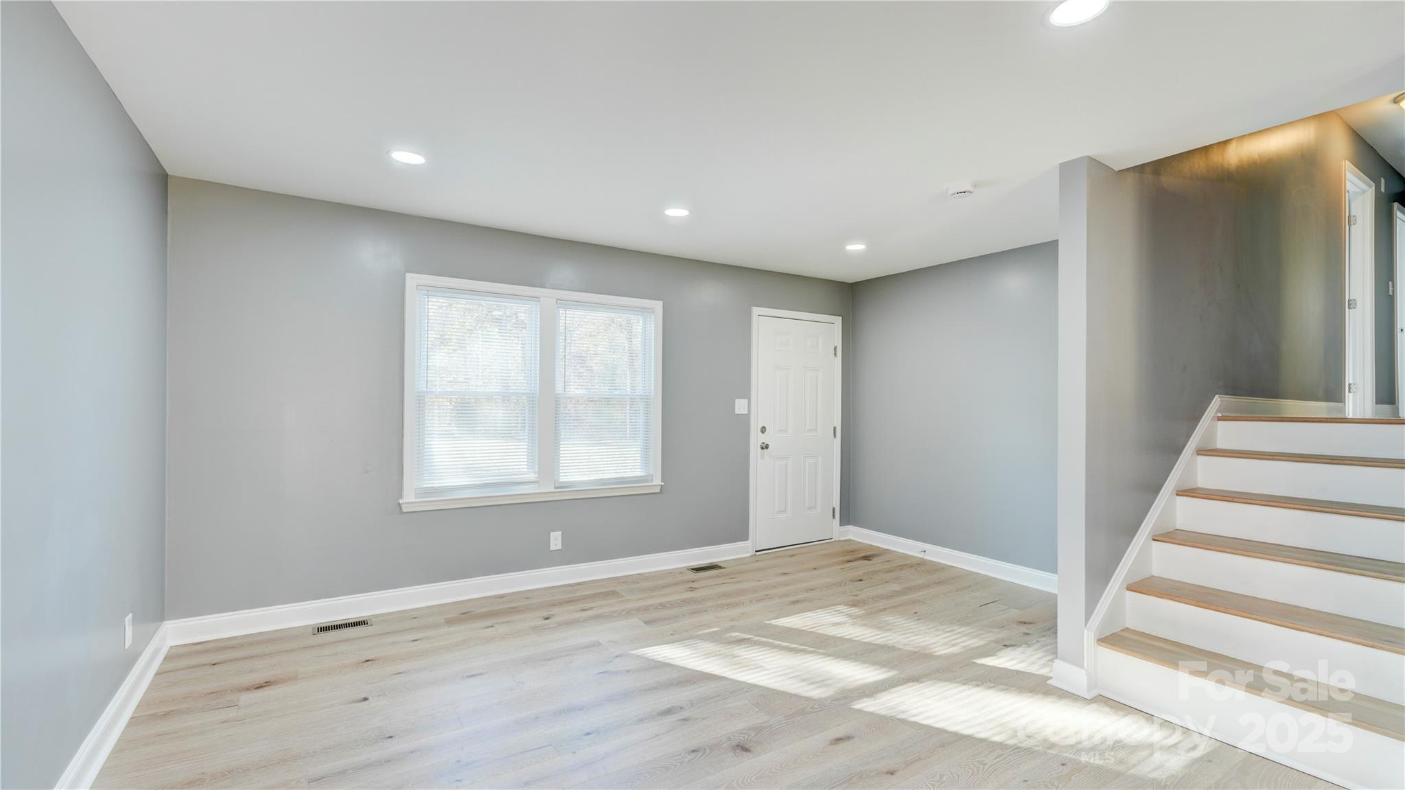 460 Chalk Maple Road China Grove, NC 28023 - Photo 9 of 33 a view of an empty room with wooden floor and a window