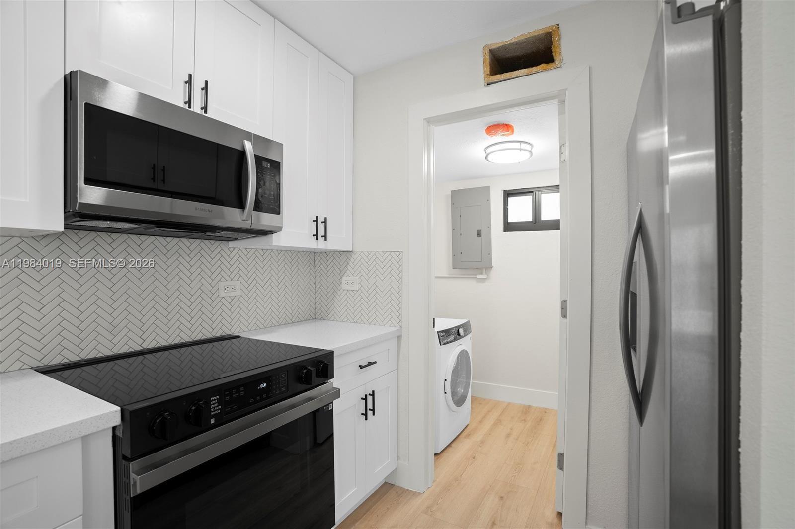 a kitchen with stainless steel appliances a refrigerator stove and microwave