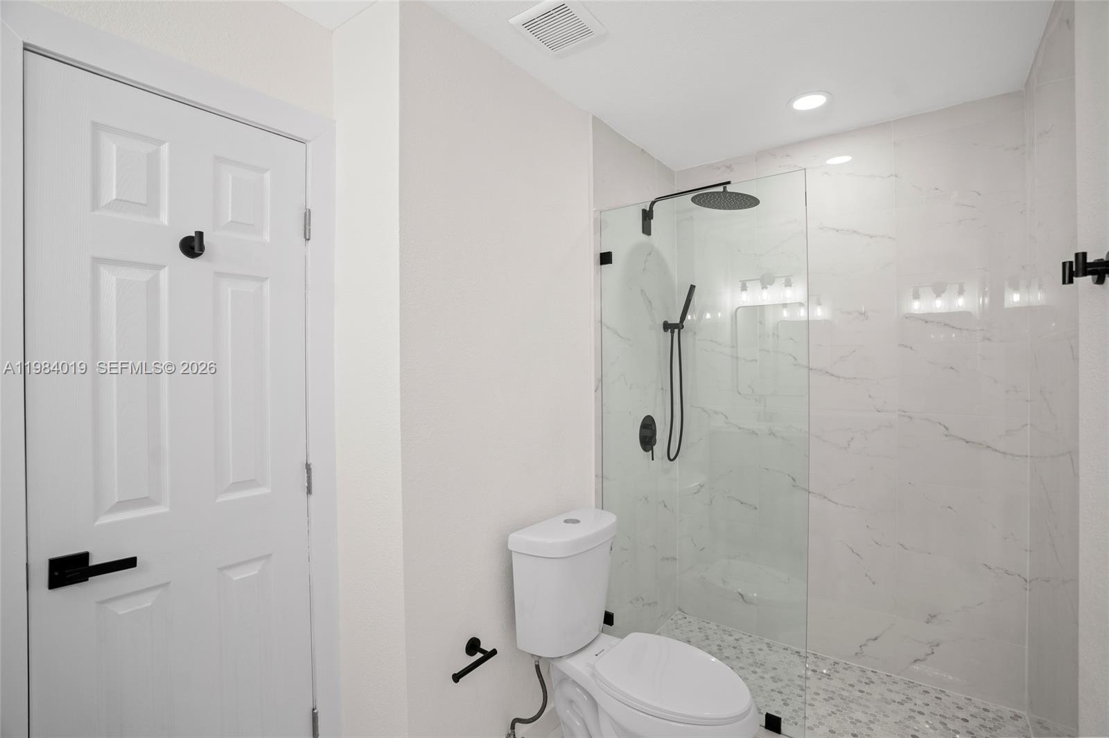 28015 Southwest 143rd Court Homestead, FL 33033 - Photo 20 of 29 a bathroom with a toilet and shower