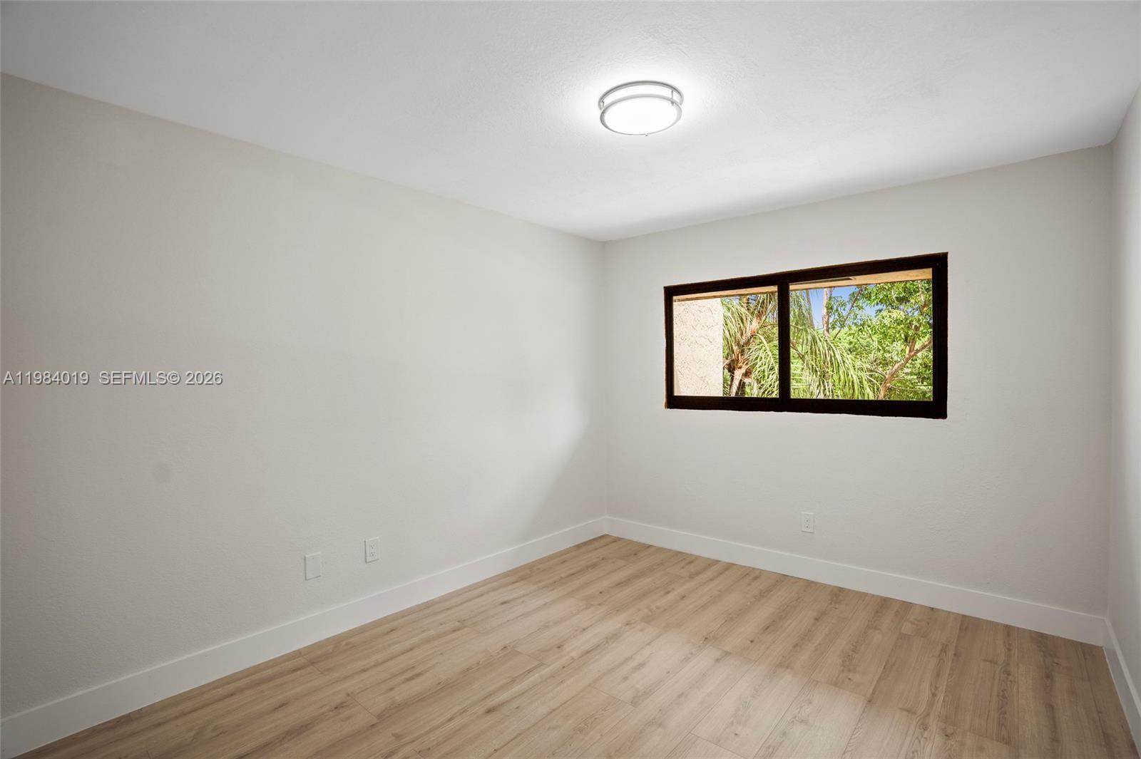 28015 Southwest 143rd Court Homestead, FL 33033 - Photo 23 of 29 an empty room with wooden floor and windows