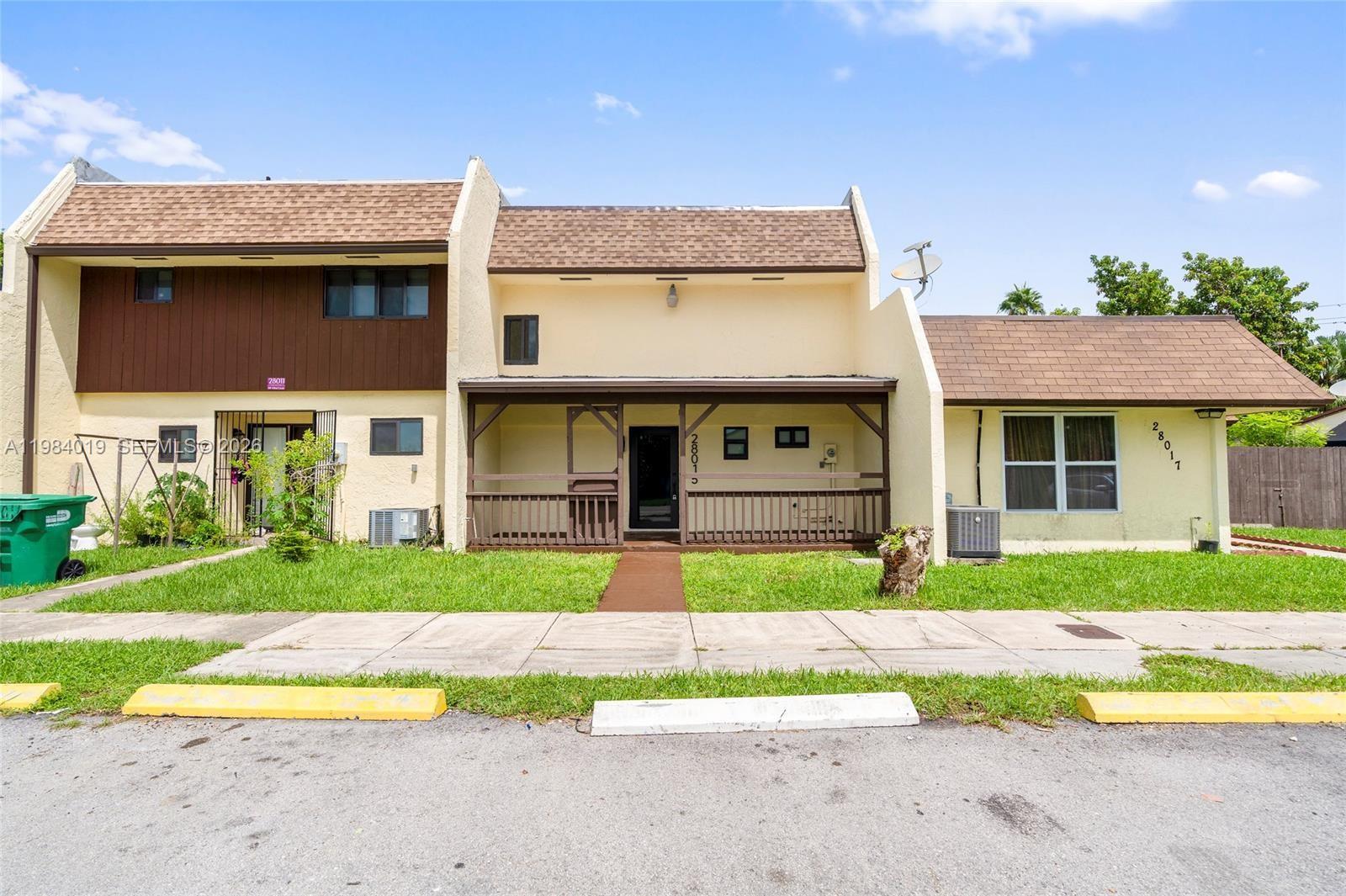 28015 Southwest 143rd Court Homestead, FL 33033 - Photo 28 of 29 a view of a brick house with a yard patio and a yard