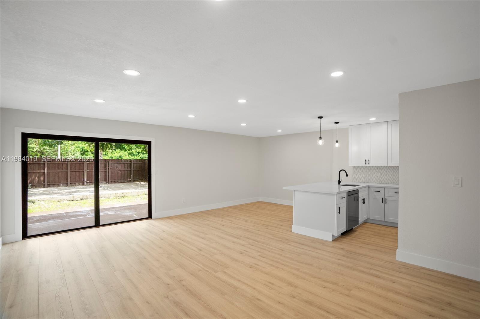 28015 Southwest 143rd Court Homestead, FL 33033 - Photo 8 of 29 a view of an empty room with wooden floor and a window