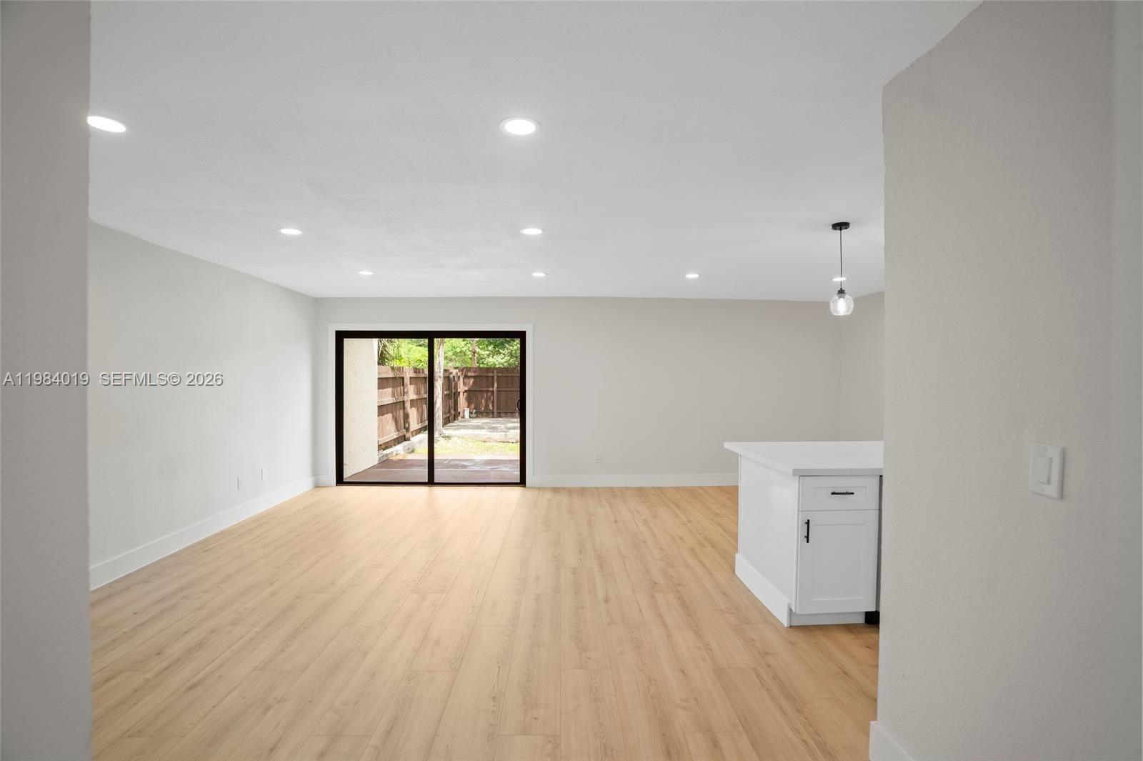 28015 Southwest 143rd Court Homestead, FL 33033 - Photo 9 of 29 wooden floor in an empty room with a window