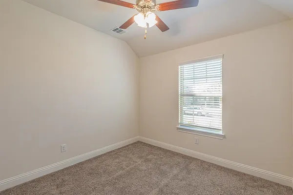 an empty room with a chandelier fan