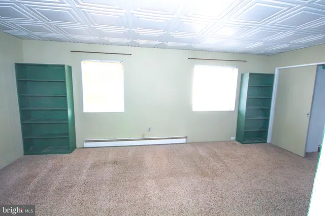 an empty room with windows and closet