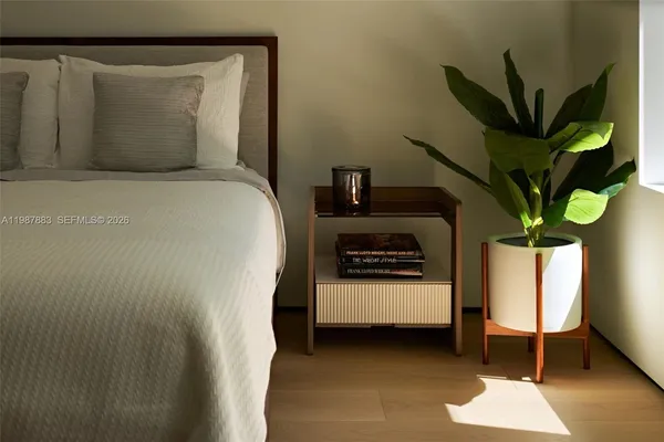 a large bedroom with a bed and wooden floor