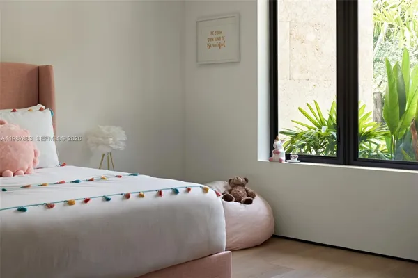 a bedroom with a bed and window