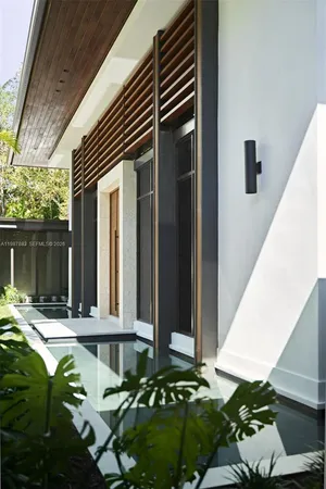 a living room filled with furniture and a large window
