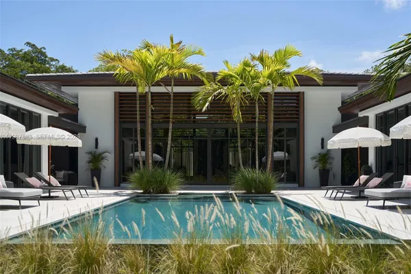 a view of a chairs and table in the balcony