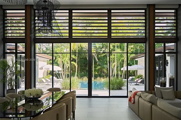 a living room with furniture and large windows