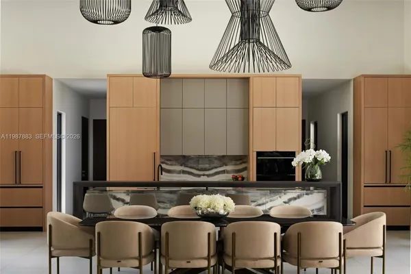 a dining room with furniture and a floor to ceiling window