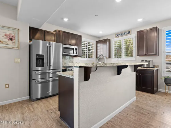 a kitchen with granite countertop stainless steel appliances and sink
