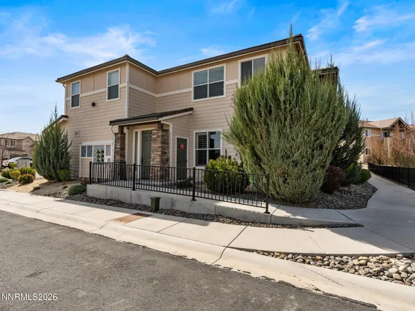 an aerial view of a house with a yard