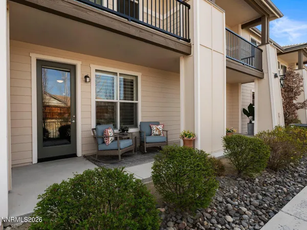 a view of a balcony with couches and potted plants