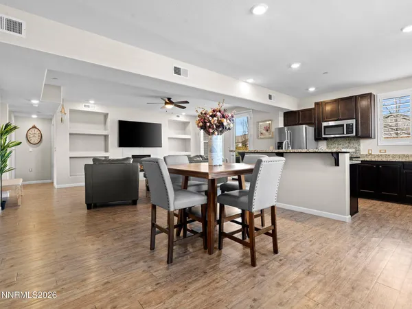 a view of a dining room with furniture and chandelier