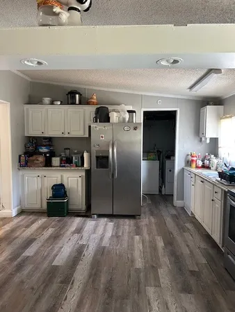 a kitchen with kitchen island a counter top space a sink and cabinets
