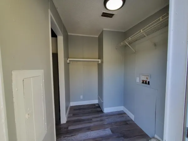 a view of a hallway with wooden floor