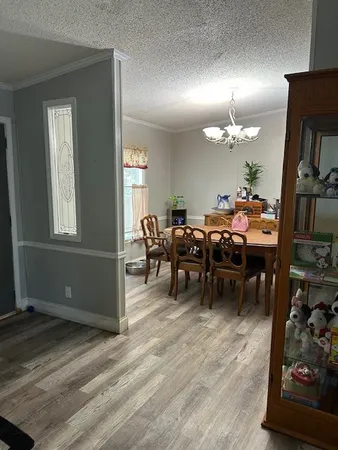 a view of a dining room with furniture and chandelier