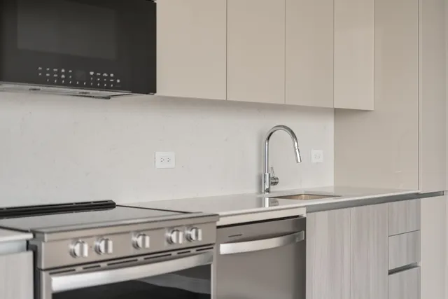 a close view of a sink and cabinets
