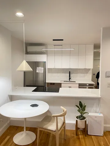 a kitchen with a table and chairs