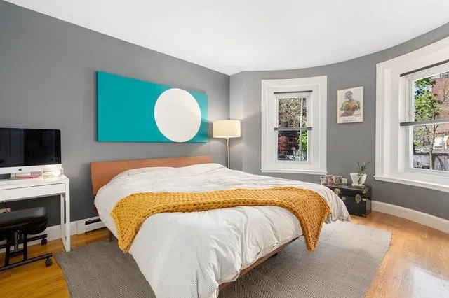 a bed sitting in a bedroom next to a window