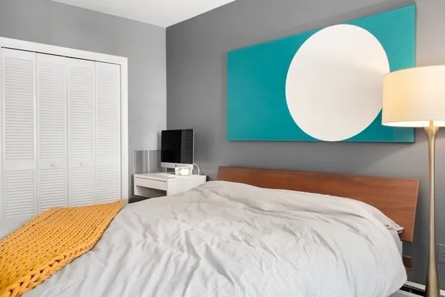 a bedroom with a bed and a flat screen tv