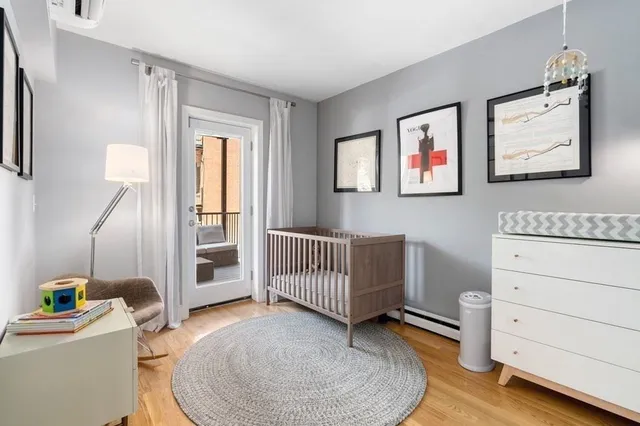 a room with a baby crib furniture and a dresser