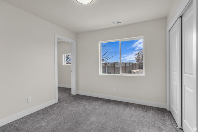 576 7th Avenue Midvale, UT 84047 - Photo 21 of 32 Unfurnished bedroom with a closet and carpet floors