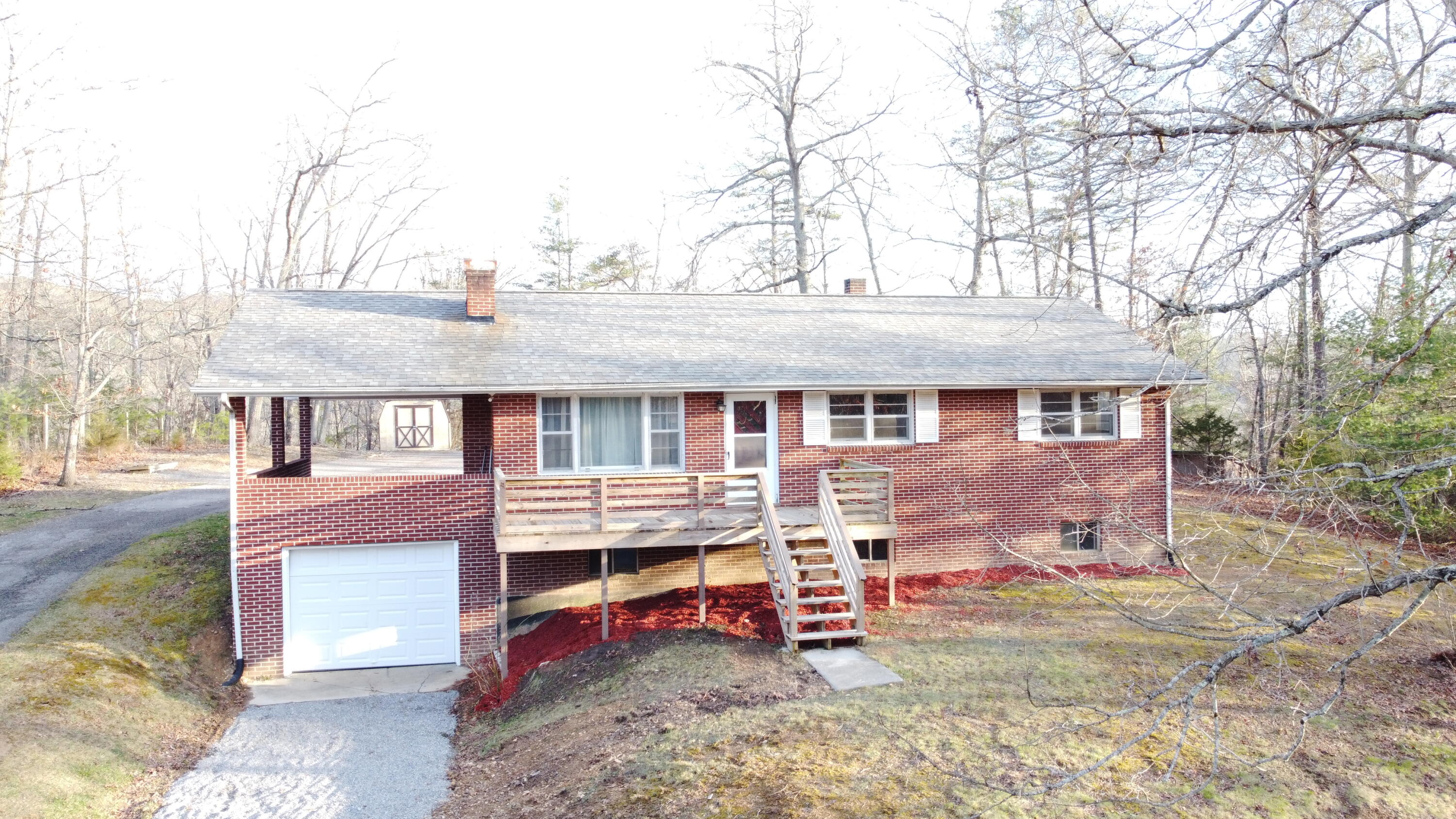 3909 North Fork Road Elliston, VA 24087 - Photo 1 of 22 front view of a house with a chair and table