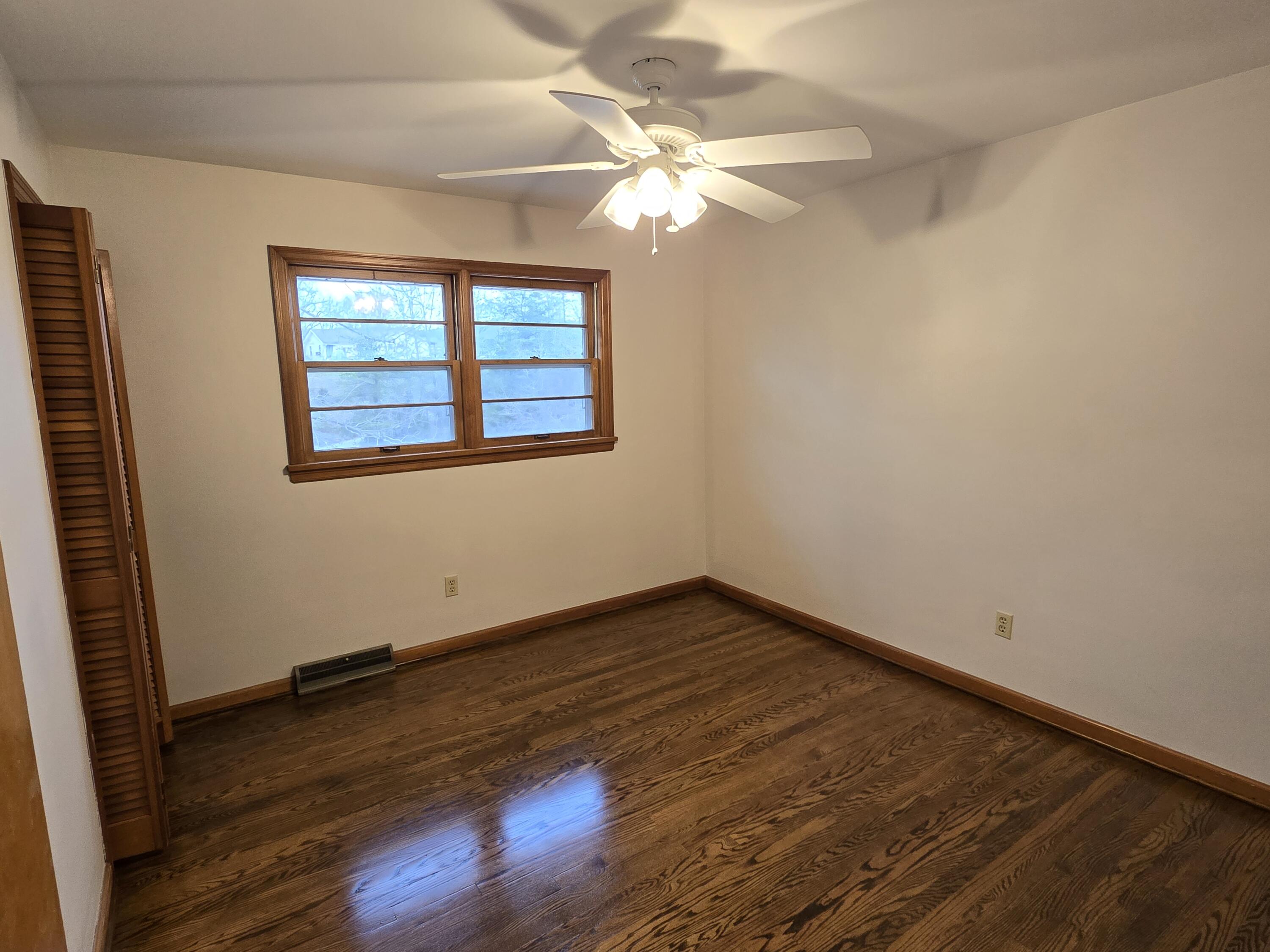 3909 North Fork Road Elliston, VA 24087 - Photo 8 of 22 a view of an empty room with wooden floor and a window