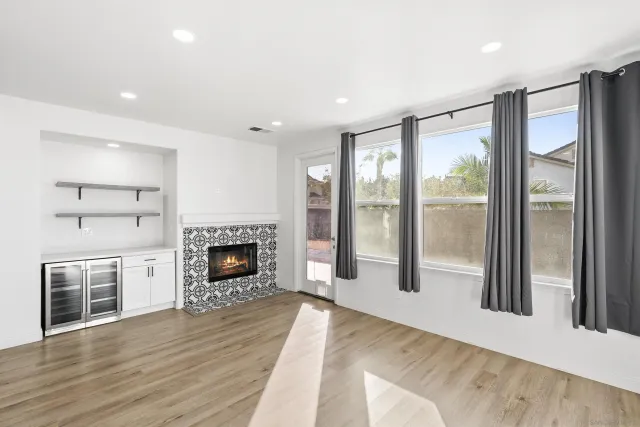 a view of a livingroom with a fireplace wooden floor and window