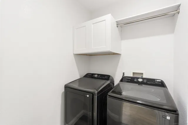 a view of storage and utility room with washer and dryer