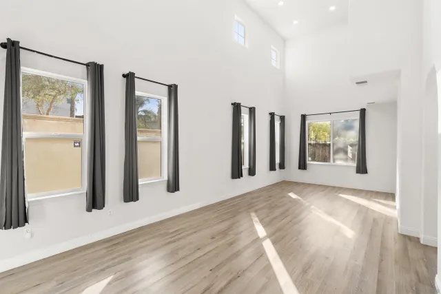 a view of a big room with windows and closet